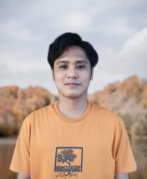 Half body portrait of Chris Ben Lim by a lake scenery